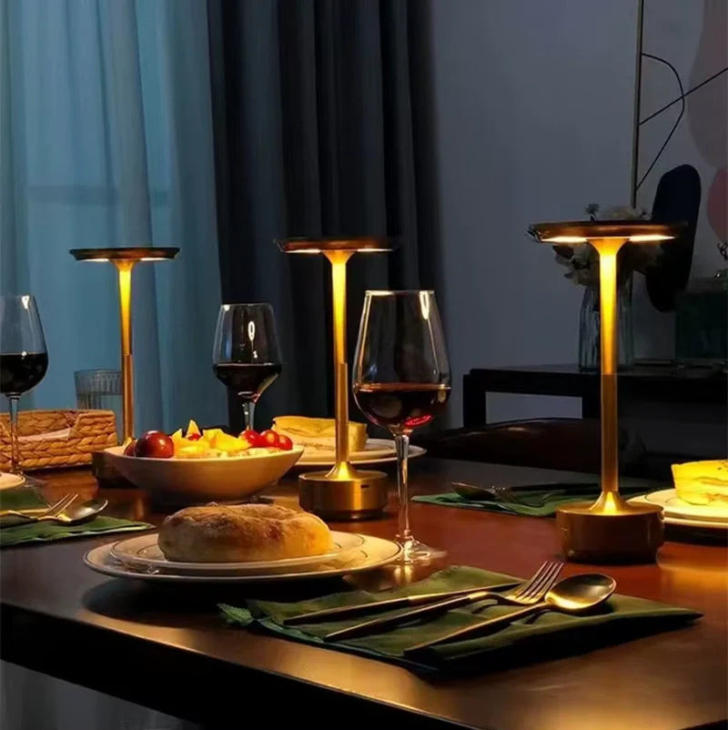 Bellvian modern LED table lamps on elegant dining table with champagne glasses and warm ambient light.