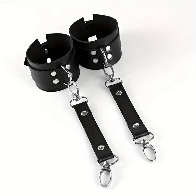 Bellvian black BDSM cuffs with leather inspired finish and fetish roleplay styling, designed as erotic bedroom accessories for sexy couple nights, intimate fashion trends and luxury anniversary or Valentine’s gifts in the UK