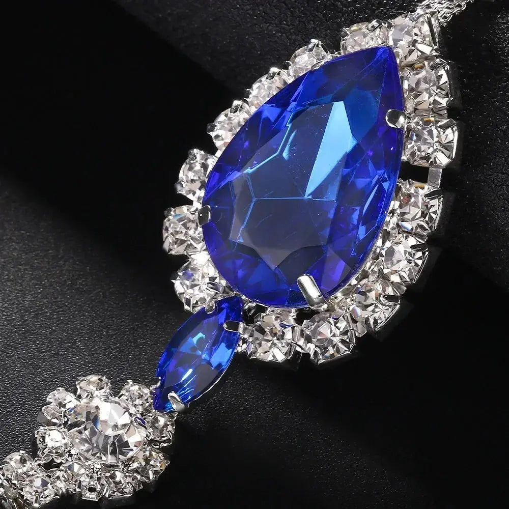 Close up view of an elegant blue crystal pendant surrounded by sparkling rhinestones and premium jewellery craftsmanship. Ideal for shoppers searching for luxury lingerie accessories, rhinestone lingerie jewellery, sexy bedroom accessories, glamorous intimate fashion and statement lingerie details designed to elevate special occasions.