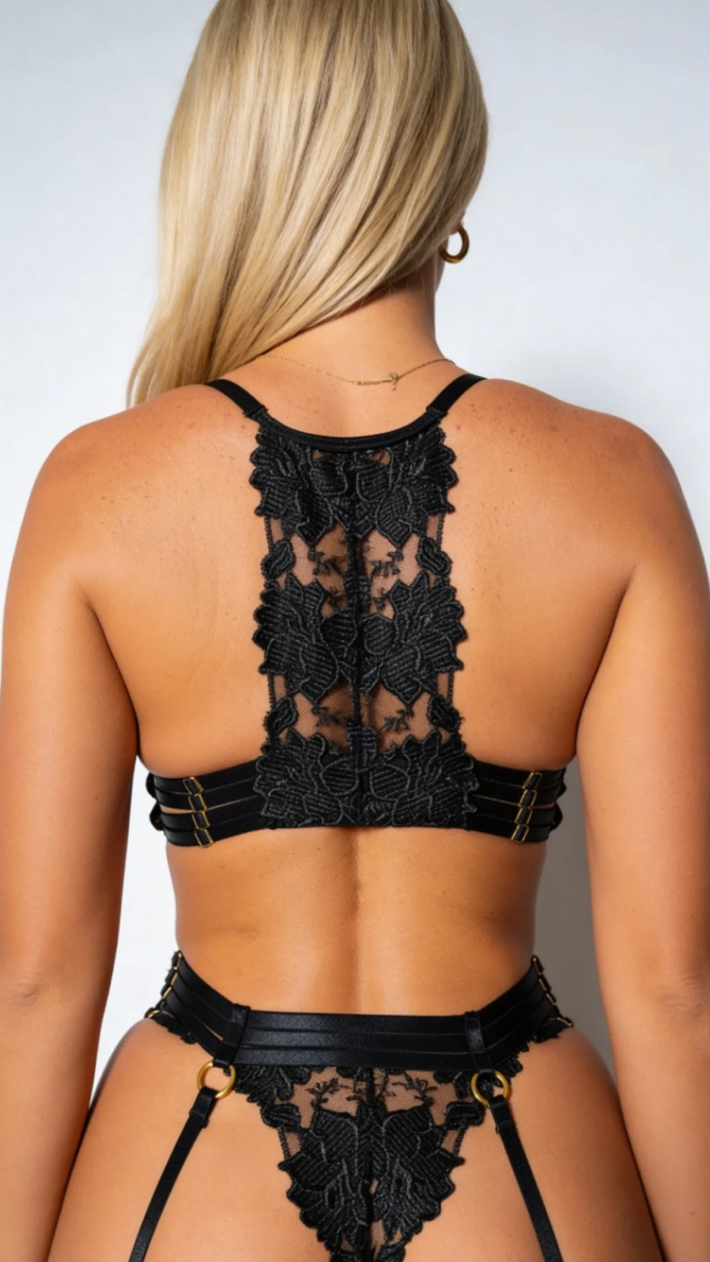 Detailed rear view close-up of Bellvian™ bridal lingerie black bra, focusing on the intricate floral lace racerback design, multi-strap band extensions, and sheer mesh composition, tailored for an exquisite anniversary gift for wife online search.
