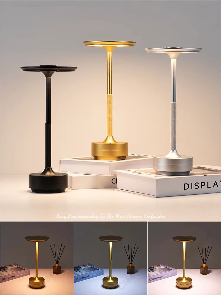 Bellvian gold aluminum LED table lamp placed on a natural wooden dining table, creating a warm and cozy ambient light atmosphere in a stylish dining room setting.