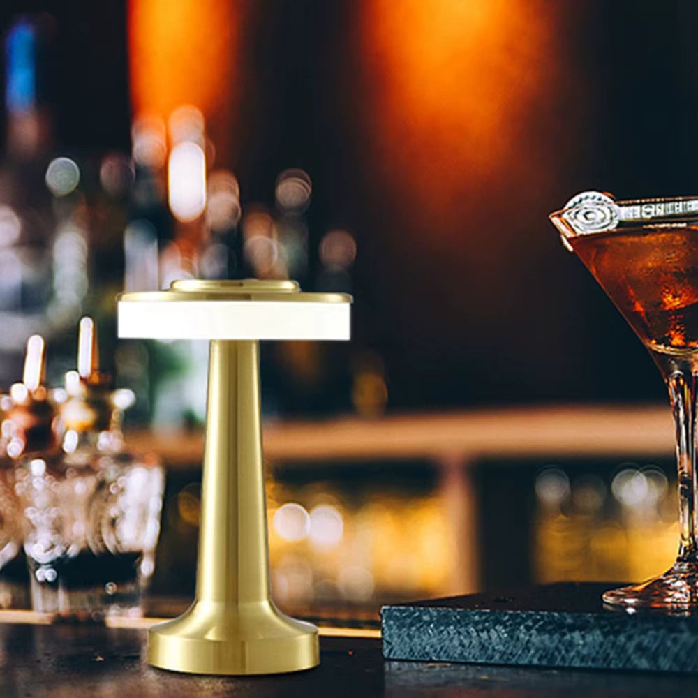 Minimalist table lamp with warm glow placed on a marble side table next to a designer chair  Bellvian luxury lighting design.