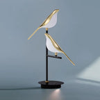 Minimalist Bellvian modern bird LED lamp with black base and gold body, stylish UK home decor lighting.