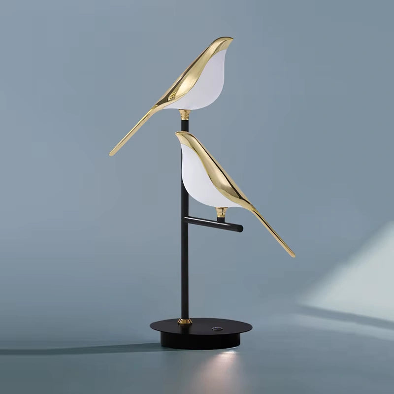 Minimalist Bellvian modern bird LED lamp with black base and gold body, stylish UK home decor lighting.