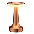 Minimalist bedside table lamp glowing warmly beside a neatly made bed with neutral tones, creating a relaxing bedroom atmosphere  Bellvian lighting.