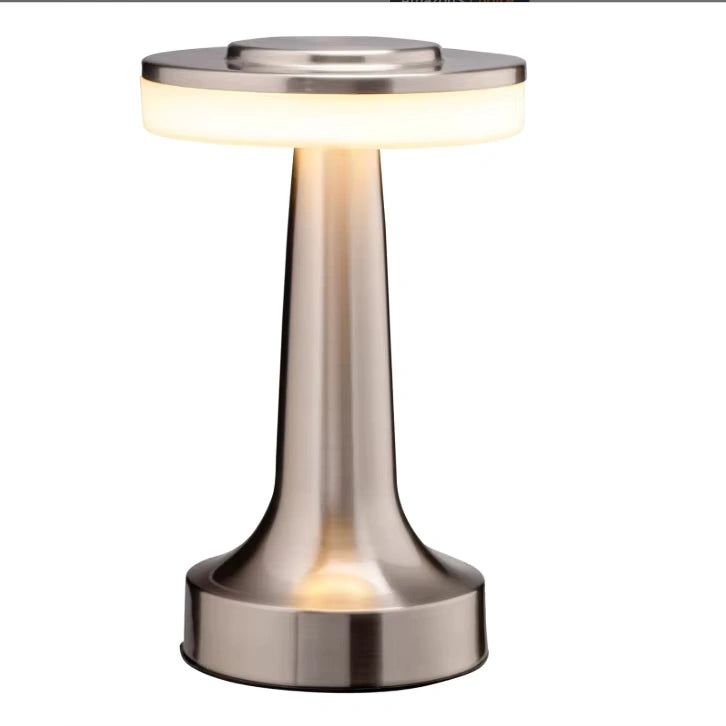 Bellvian minimalist table lamp illuminating a cozy modern living room with soft golden light, reflecting elegance and sophistication.