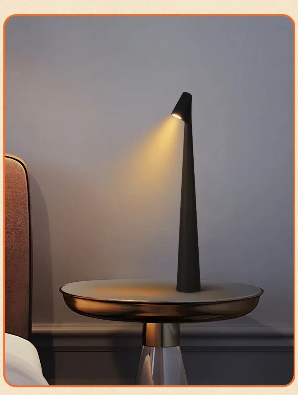 Black minimalist LED bedside lamp emitting soft golden light on a modern round side table next to a bed, creating an elegant nighttime atmosphere. Bellvian