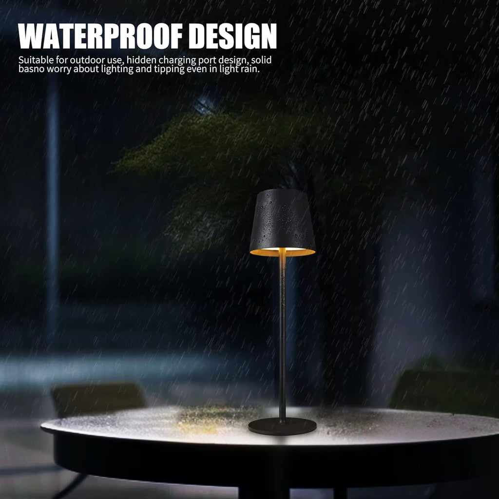 Black waterproof LED table lamp designed for outdoor use, shown glowing beautifully under light rain. Durable, rechargeable, and perfect for patios, gardens, and restaurants.
