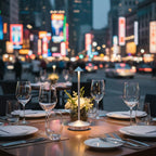 Cordless LED table lamp glowing softly on a restaurant table with glassware and flowers, surrounded by city lights and blurred night traffic in the background — perfect modern ambient lighting for outdoor dining.