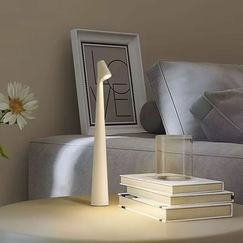 Tall cream-colored LED floor lamp standing beside a sofa and decorative LOVE frame, softly lighting the beige toned living room with a modern cozy vibe. Bellvian