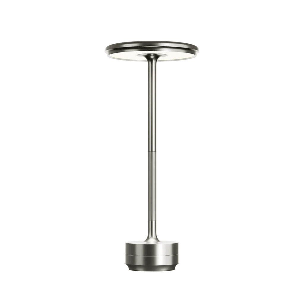 Modern silver aluminum touch LED table lamp featuring sleek circular head, slim cylindrical stand, and minimalist base, photographed on white background.