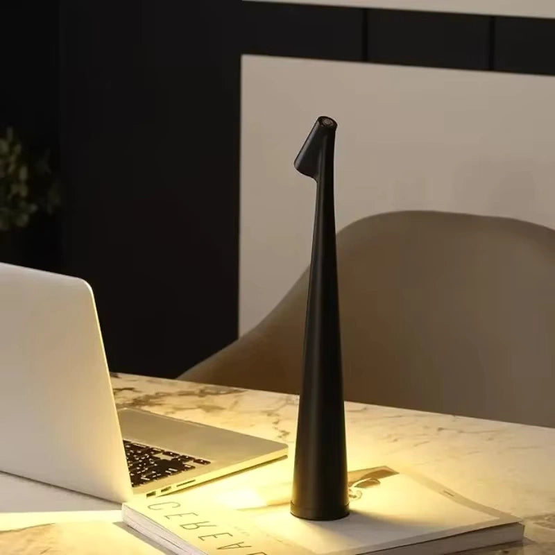 Sleek black LED desk lamp providing warm light on a marble office desk with a laptop and books, ideal for modern workspaces and reading corners.