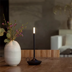 Sophisticated LED table lamp with gold metallic accents and circular base, designed with wireless rechargeable battery and warm light tone. Perfect for contemporary interiors — Bellvian luxury lighting piece.