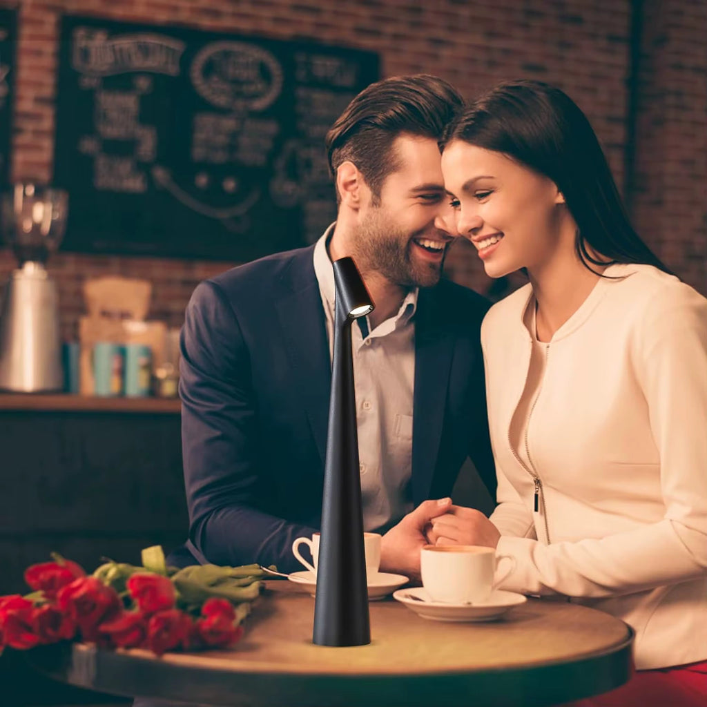 Romantic couple sitting at a café table softly lit by a black LED lamp, surrounded by a warm cozy atmosphere  ideal lighting for date nights and restaurants. Bellvian
