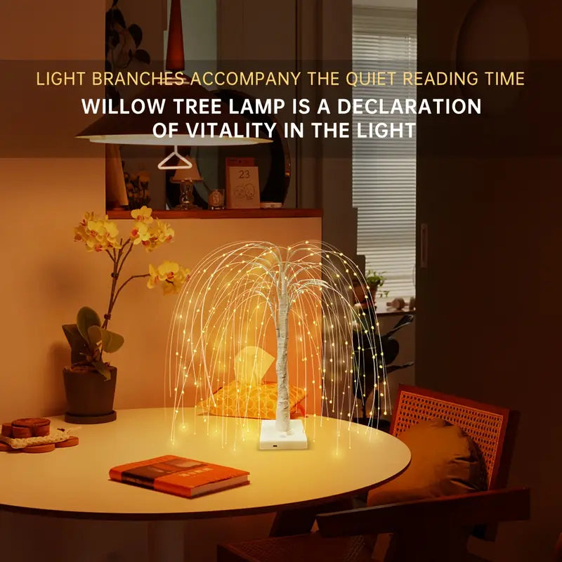 LED willow tree lamp illuminating a reading desk with books, flowers, and warm-toned decor. The golden hanging lights create a calm and cozy reading corner, perfect for home, study, or ambient bedroom lighting. Bellvian